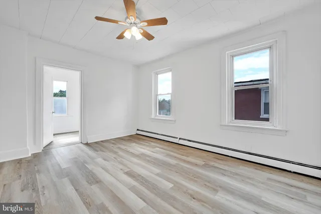 a view of an empty room with wooden floor