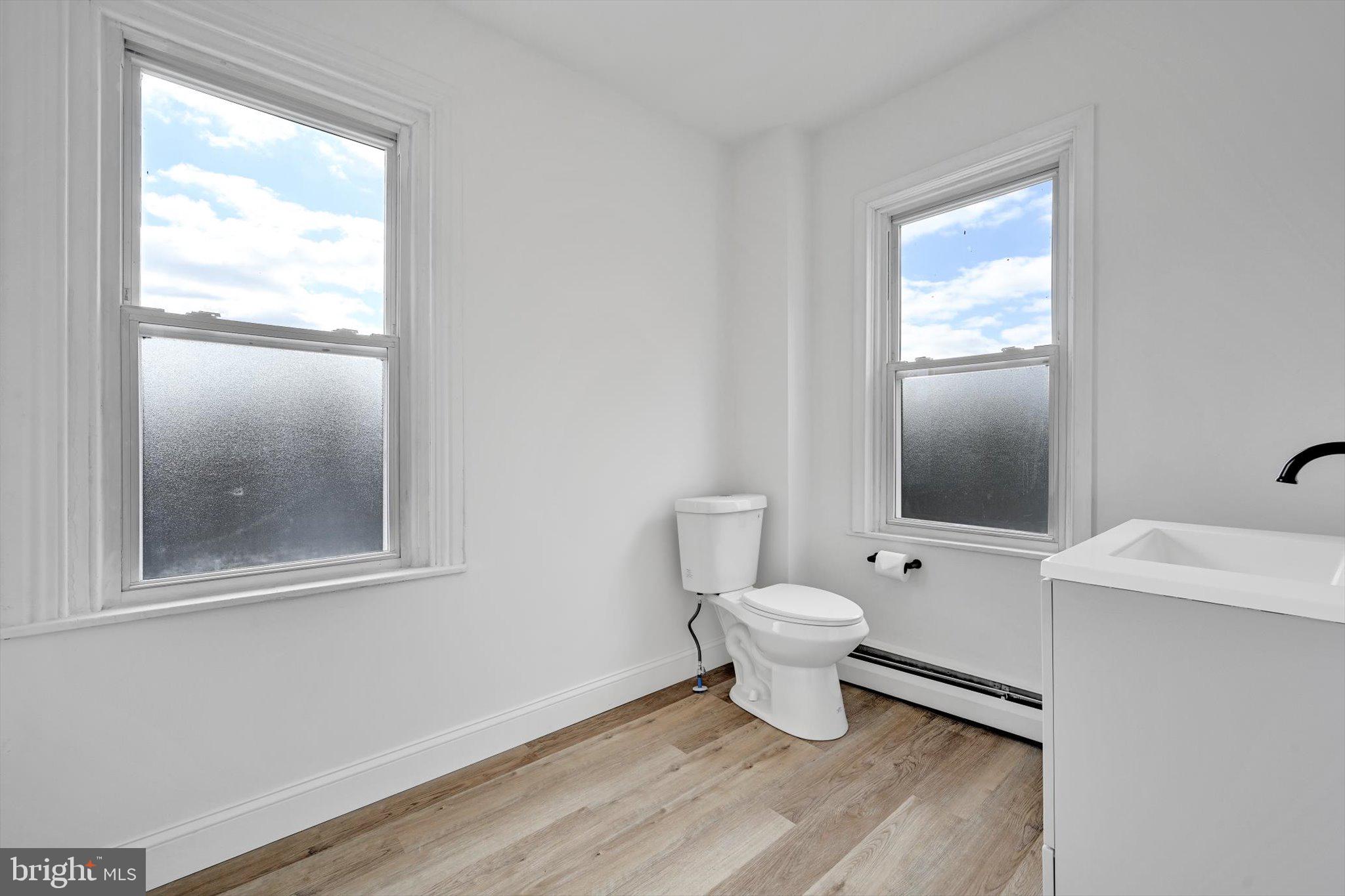 170 South Franklin Street Pottstown, PA 19464 - Photo 19 of 31 a bathroom with a toilet sink and mirror