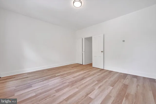 a view of an empty room and wooden floor