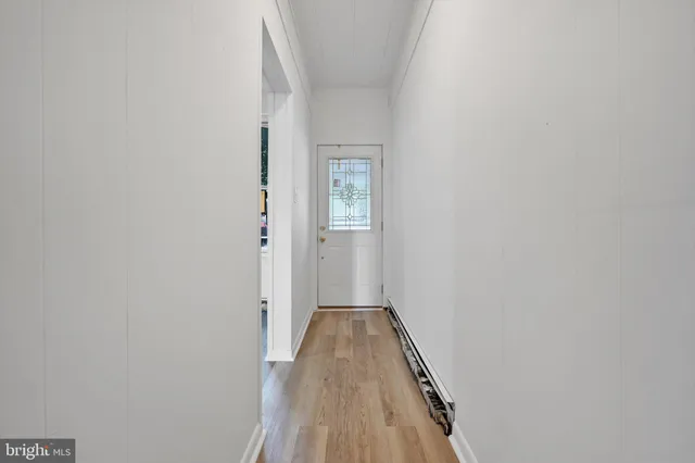 a view of a hallway with wooden floor
