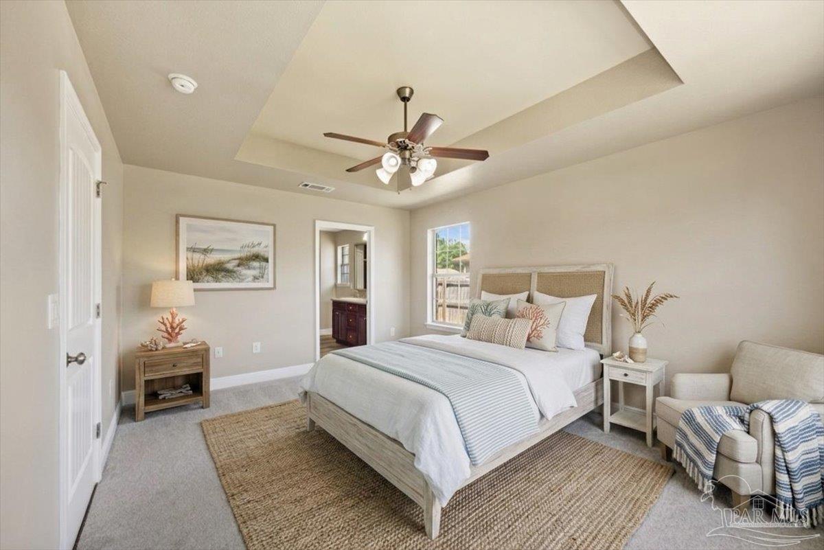 4015 Berry Circle Pace, FL 32571 - Photo 32 of 48 a bedroom with a large bed couch and a chandelier