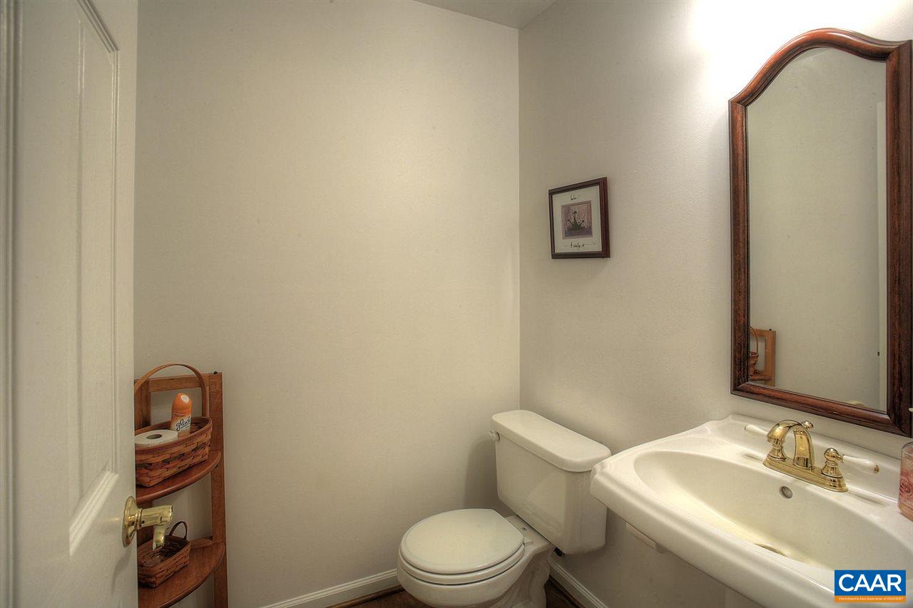 4099 Roundabout Road Louisa, VA 23093 - Photo 12 of 25 a bathroom with a toilet a sink and mirror