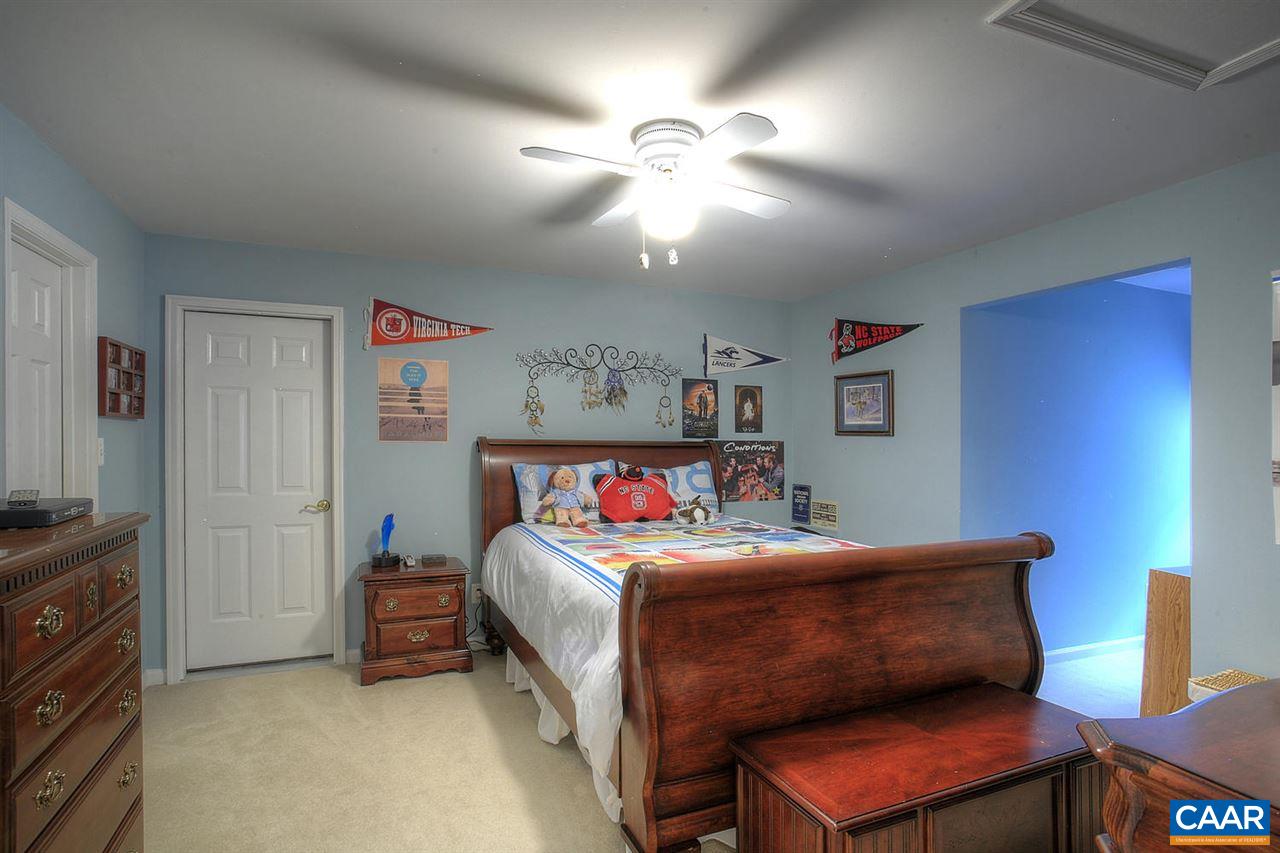 4099 Roundabout Road Louisa, VA 23093 - Photo 14 of 25 a bedroom with a bed and a chandelier