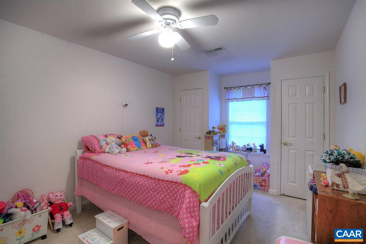 4099 Roundabout Road Louisa, VA 23093 - Photo 16 of 25 a bedroom with a bed and a chandelier