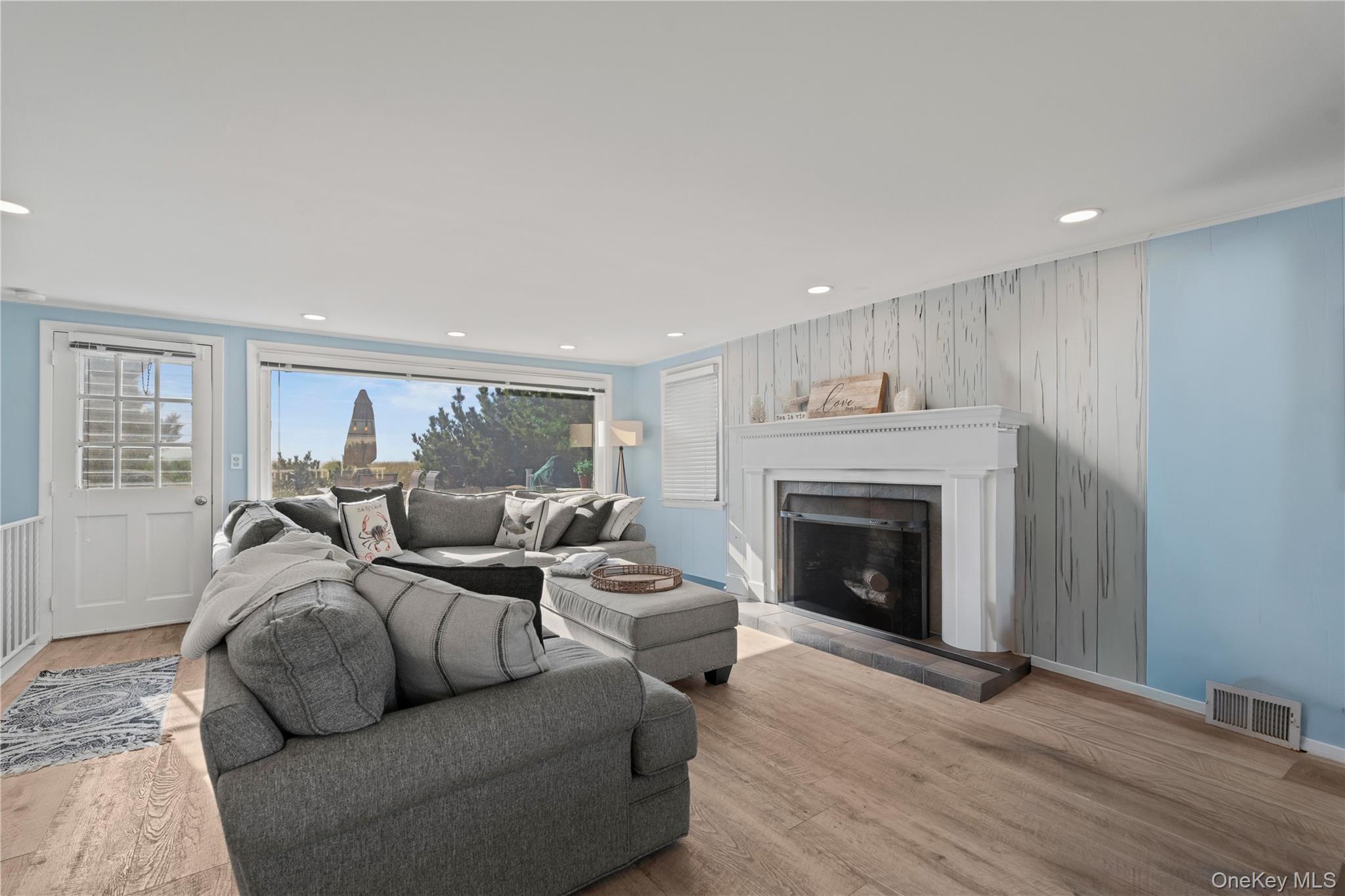 645 Dune Road Westhampton, NY 11978 - Photo 11 of 30 a living room with furniture and a fireplace