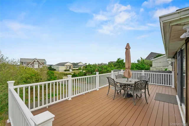 a view of a deck with wooden floor and outdoor seating
