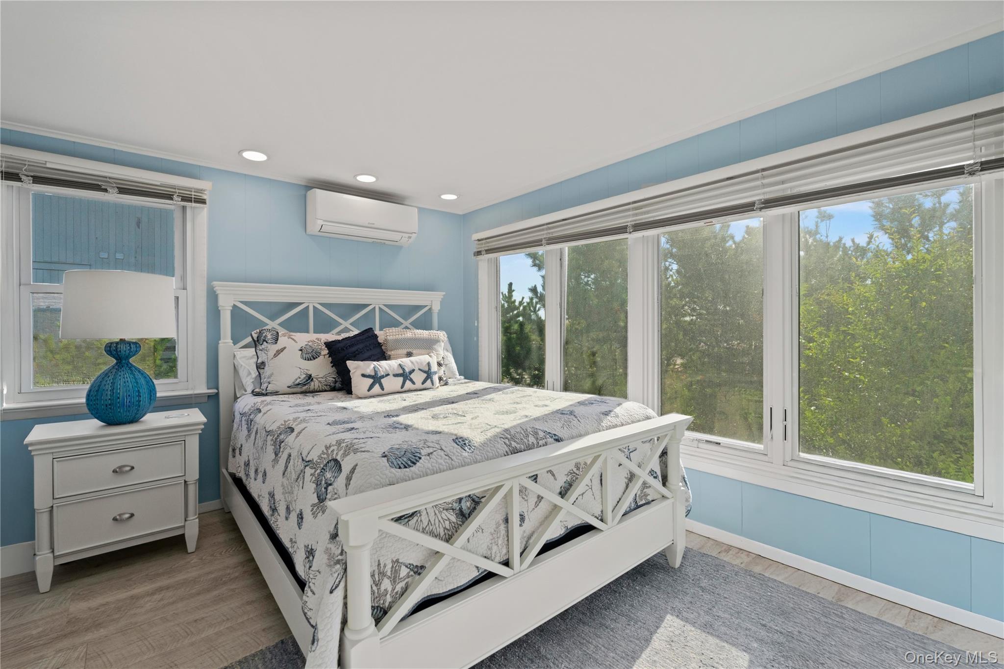 645 Dune Road Westhampton, NY 11978 - Photo 16 of 30 a bedroom with a large bed and a large window
