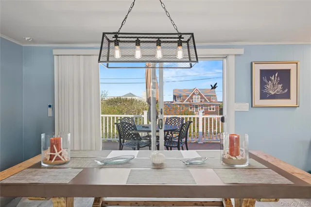 a dining room with wooden floor and glass door