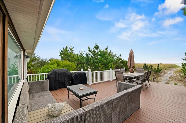 a roof deck with couches and wooden floor
