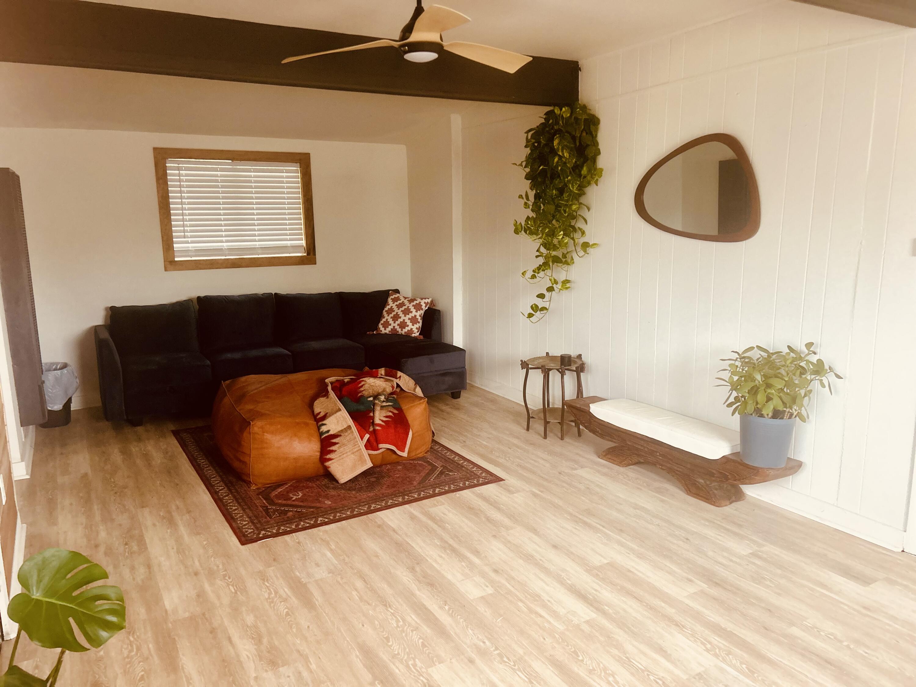 2436 24th Street, Unit BACK Lubbock, TX 79411 - Photo 3 of 6 a living room with furniture and a wooden floor