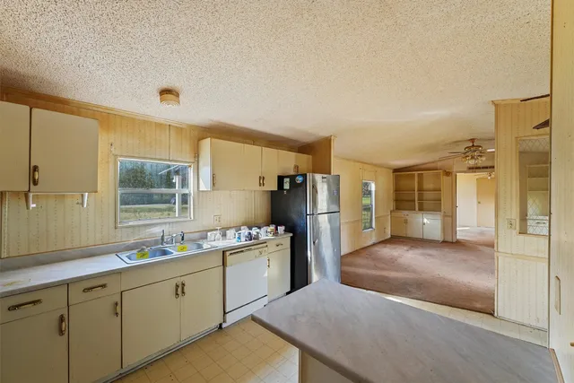 a kitchen with a sink stove and refrigerator