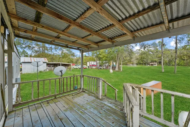 a view of a deck with a big yard next to a yard