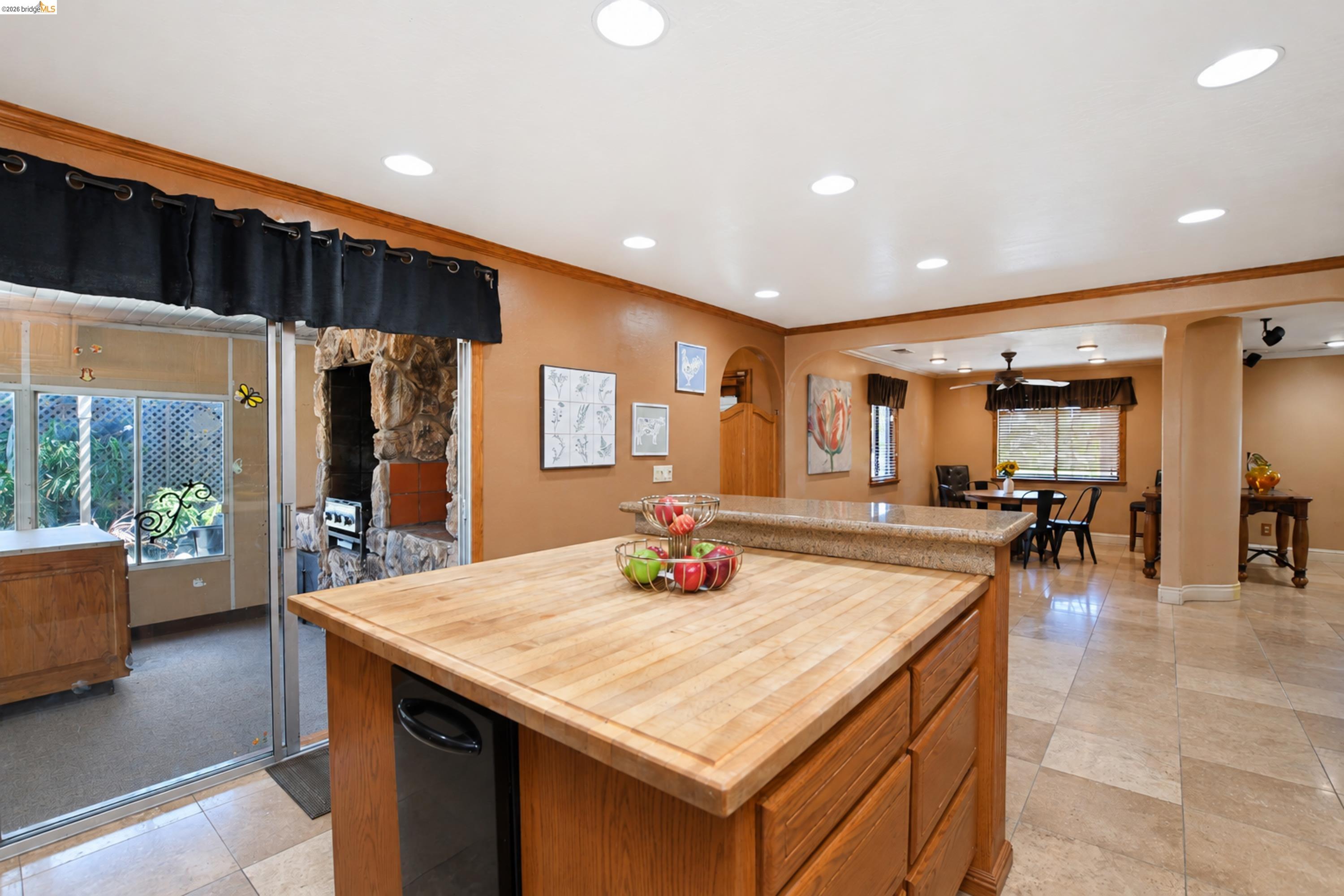 340 West Bolton Road Oakley, CA 94561 - Photo 20 of 87 Wood-finish kitchen island with integrated beverage cooler, stone-look countertop, recessed lighting, and tile flooring