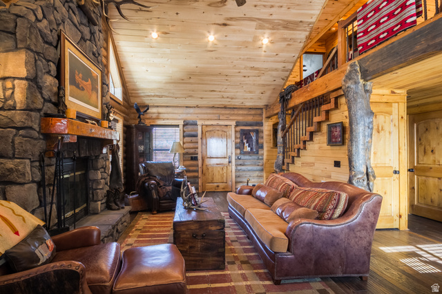 18906 North Canyon Road Whiterocks, UT 84085 - Photo 4 of 65 Living room featuring high vaulted ceiling, wooden ceiling, hardwood / wood-style floors, a stone fireplace, and stairway