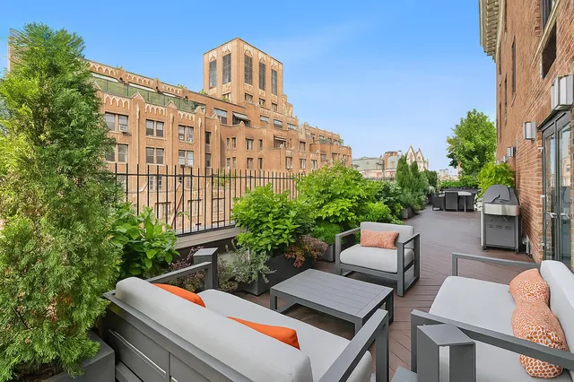 a view of a patio with couches table and chairs and potted plants