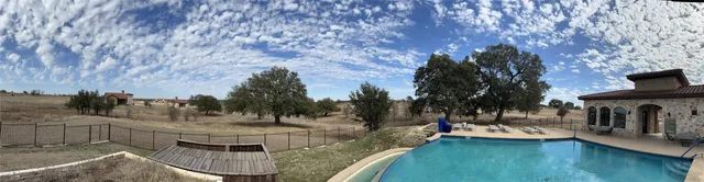 a view of a swimming pool with a patio