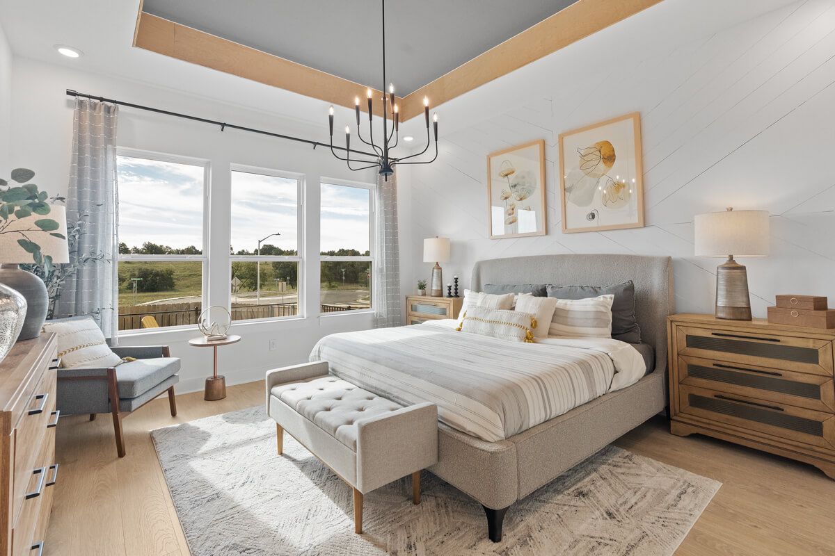 224 San Xavier Street Georgetown, TX 78633 - Photo 18 of 34 a bedroom with a large bed and a chandelier