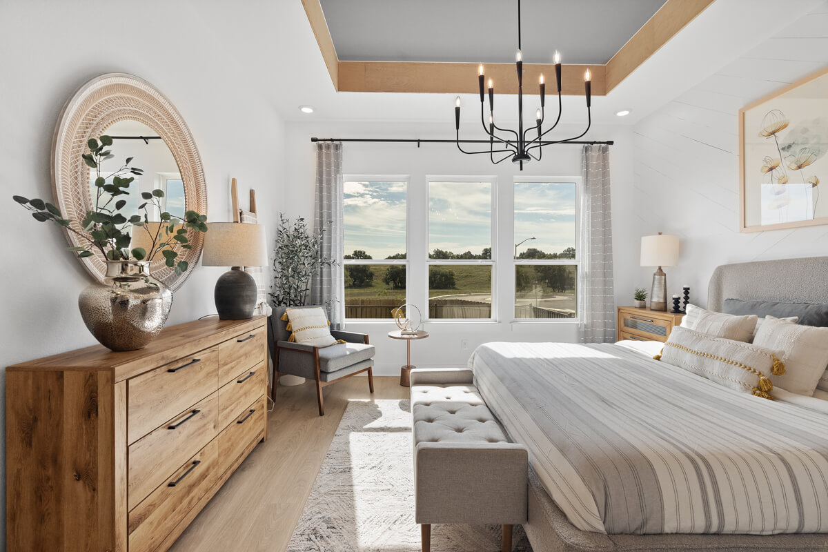 224 San Xavier Street Georgetown, TX 78633 - Photo 19 of 34 a bedroom with a bed and a chandelier