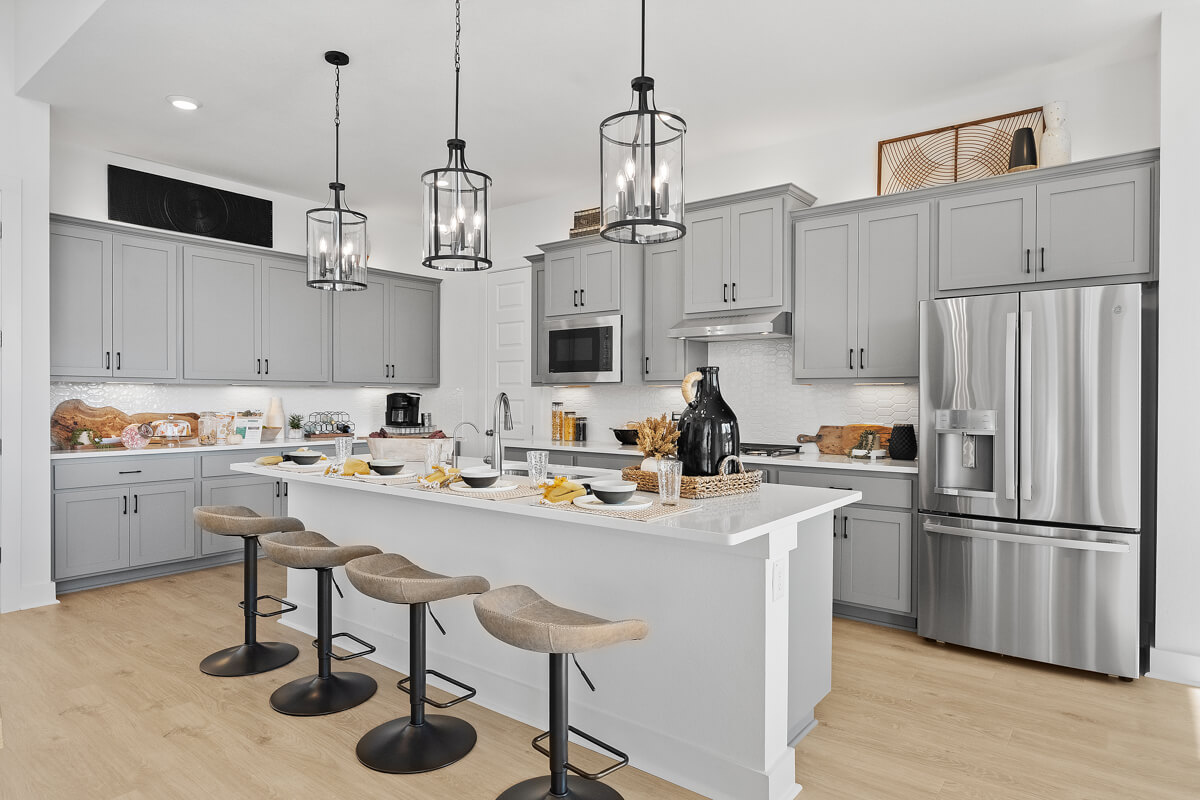 224 San Xavier Street Georgetown, TX 78633 - Photo 7 of 34 a kitchen with refrigerator cabinets and wooden floor