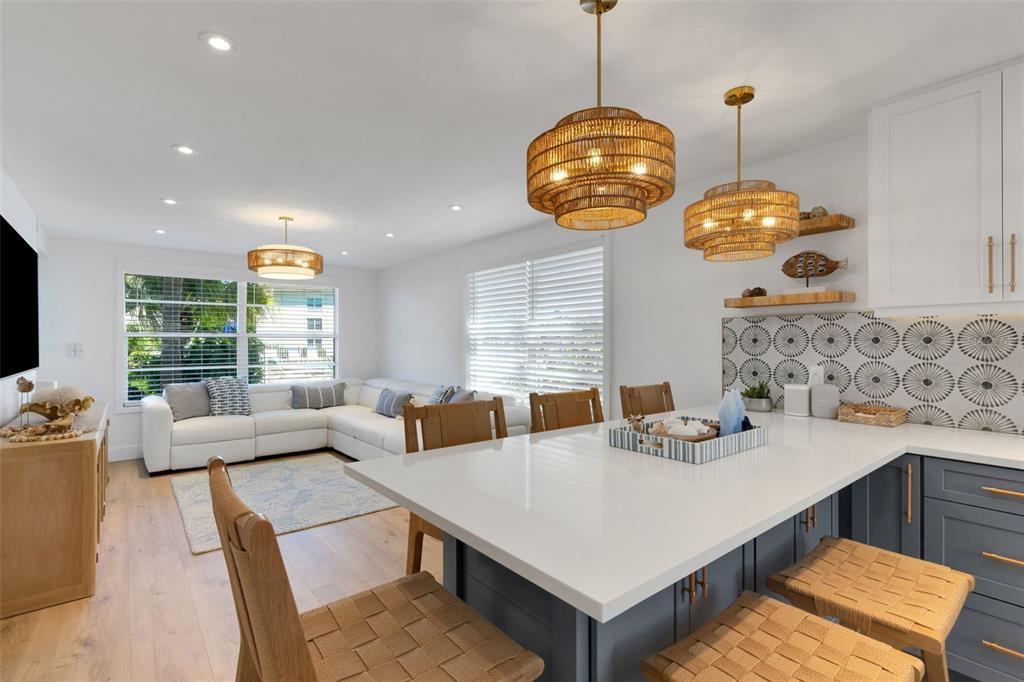 4360 Chatham Drive, Unit 108 Longboat Key, FL 34228 - Photo 11 of 56 a view of a dining room with furniture window and wooden floor