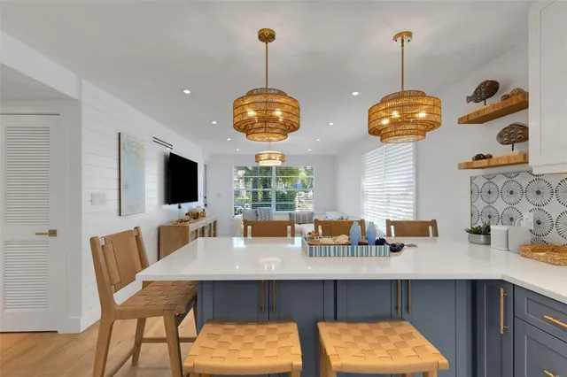 a kitchen with stainless steel appliances granite countertop a refrigerator and a stove