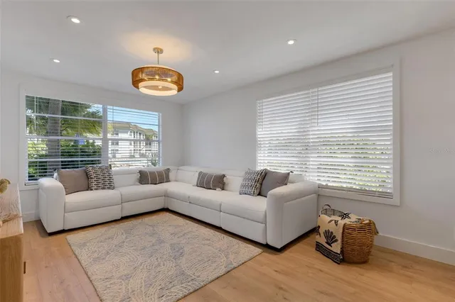 a living room with furniture wooden floor and dining table