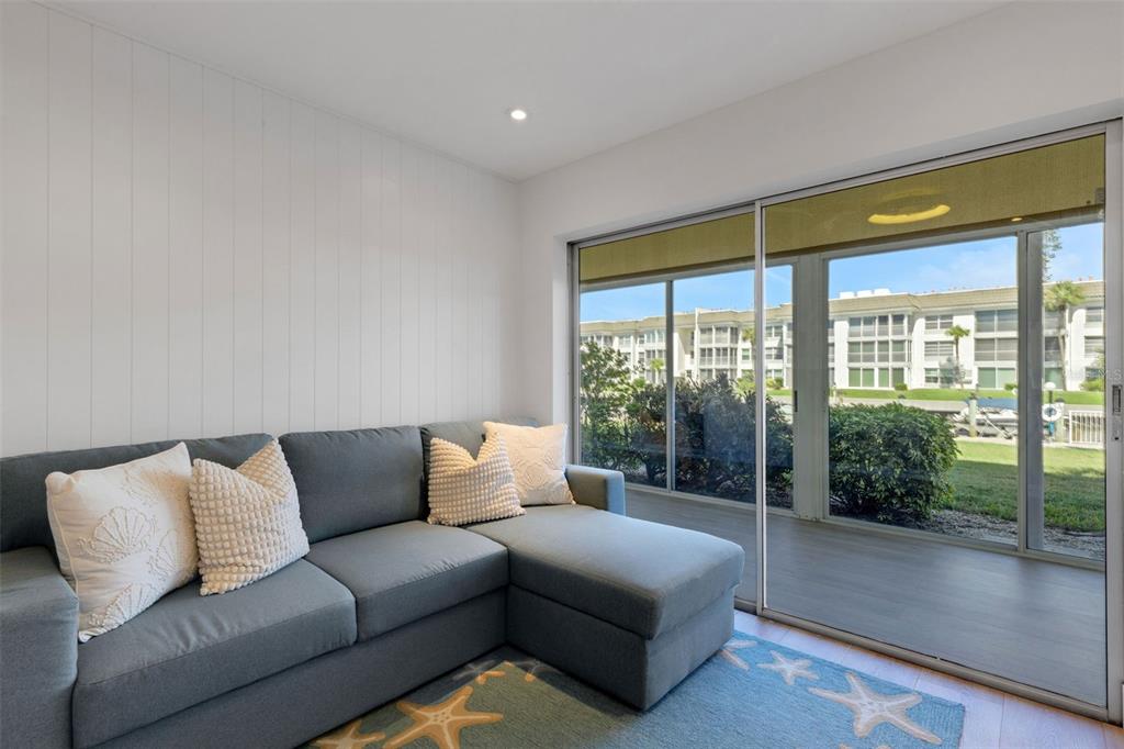 4360 Chatham Drive, Unit 108 Longboat Key, FL 34228 - Photo 23 of 56 a living room with furniture and a large window