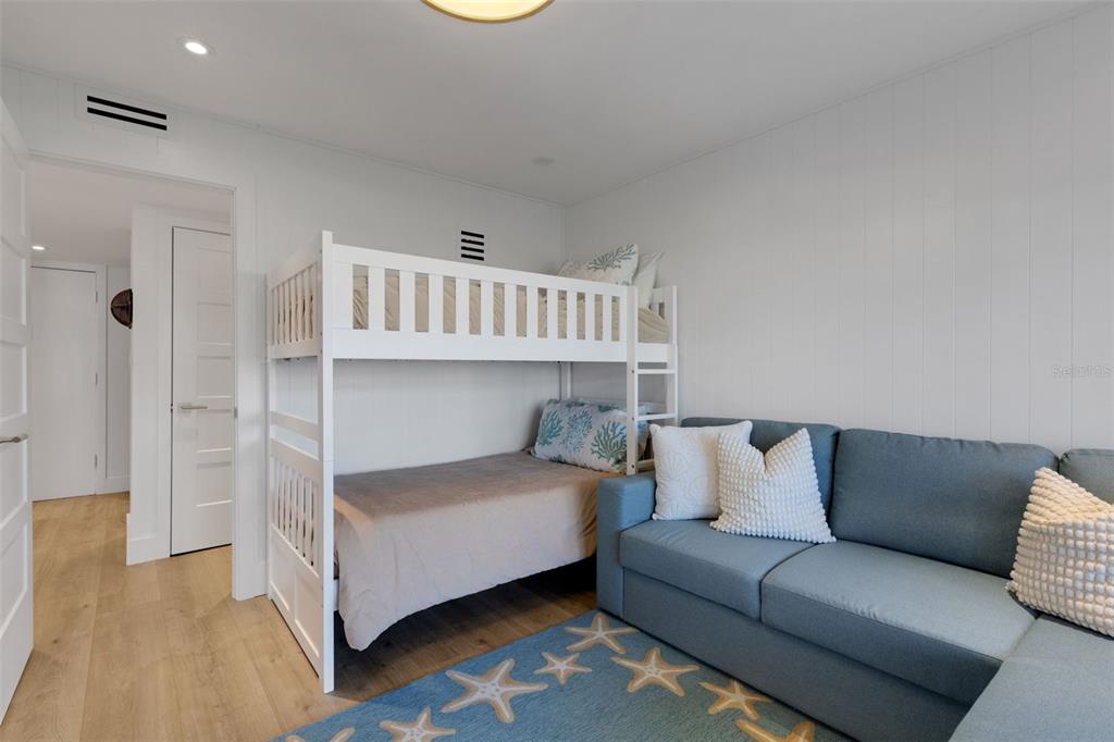 4360 Chatham Drive, Unit 108 Longboat Key, FL 34228 - Photo 24 of 56 a bedroom with a bed couch and a window