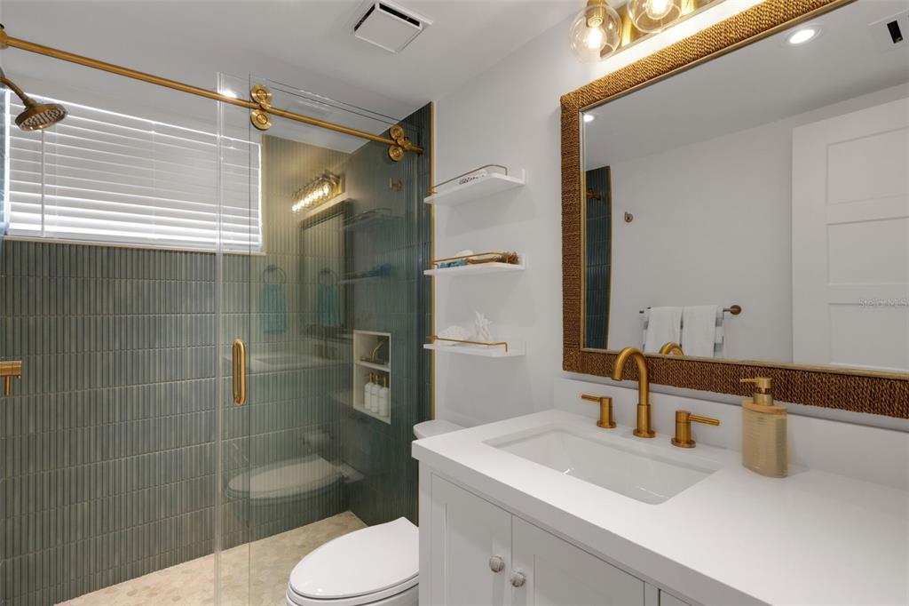 4360 Chatham Drive, Unit 108 Longboat Key, FL 34228 - Photo 26 of 56 a bathroom with a sink toilet and shower