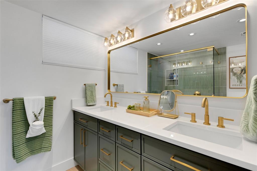 4360 Chatham Drive, Unit 108 Longboat Key, FL 34228 - Photo 33 of 56 a bathroom with a sink and a mirror