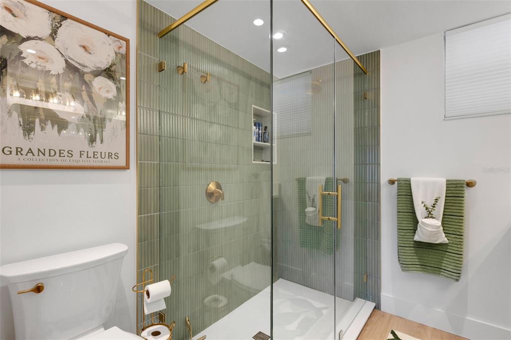 4360 Chatham Drive, Unit 108 Longboat Key, FL 34228 - Photo 34 of 56 a bathroom with a shower and toilet