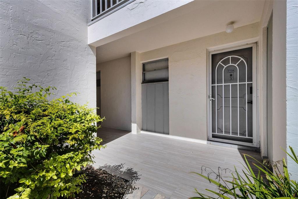 4360 Chatham Drive, Unit 108 Longboat Key, FL 34228 - Photo 39 of 56 front view of a house with a yard