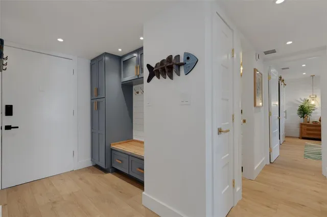 a kitchen with a table chairs refrigerator and microwave