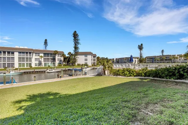 a view of a lake with couches in the patio