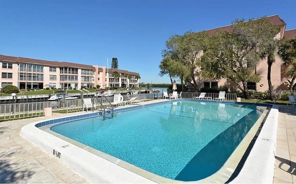 4360 Chatham Drive, Unit 108 Longboat Key, FL 34228 - Photo 48 of 56 a view of a swimming pool with outdoor seating