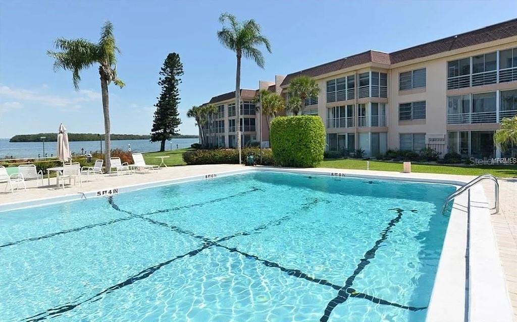4360 Chatham Drive, Unit 108 Longboat Key, FL 34228 - Photo 49 of 56 a swimming pool with outdoor seating and yard