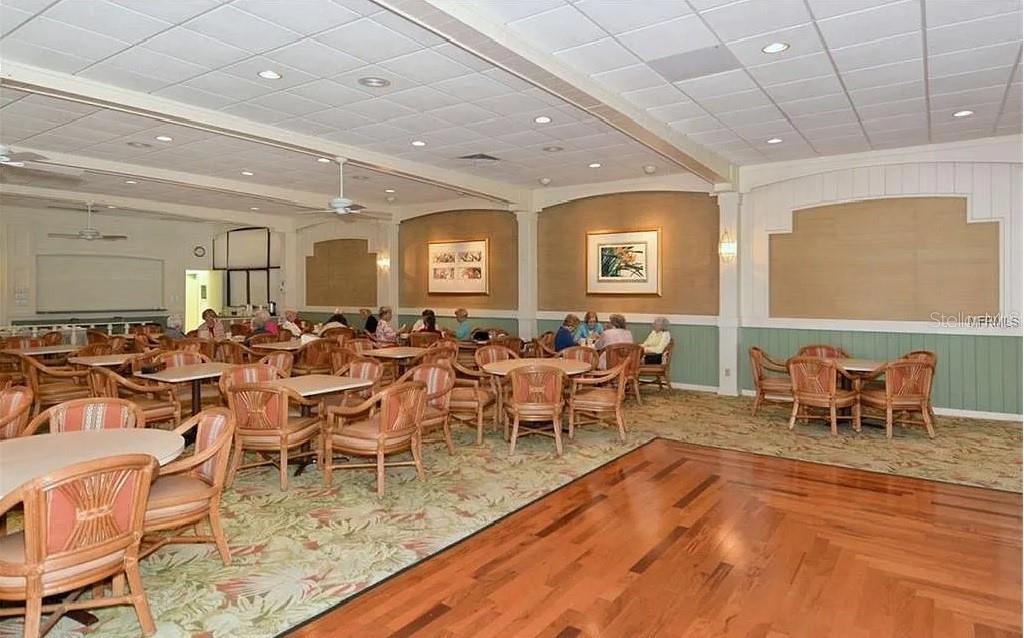 4360 Chatham Drive, Unit 108 Longboat Key, FL 34228 - Photo 50 of 56 a very nice looking dining room with lots of tables a chandelier and pool table