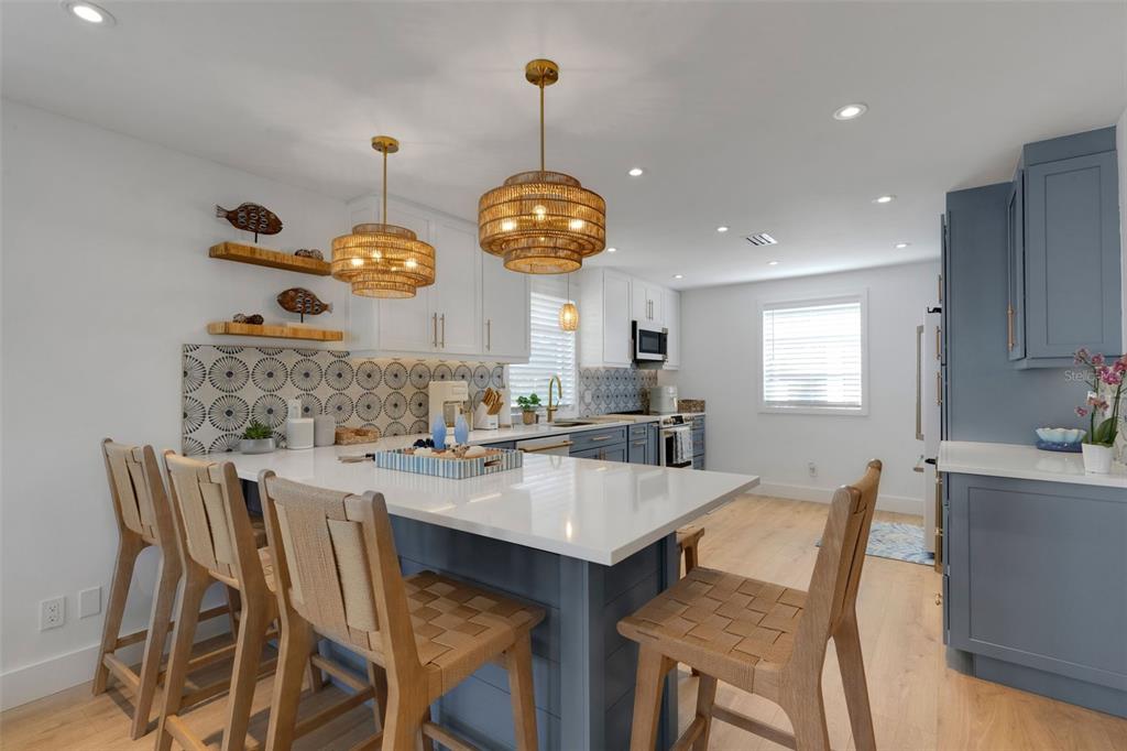 4360 Chatham Drive, Unit 108 Longboat Key, FL 34228 - Photo 8 of 56 a kitchen with a dining table and chairs