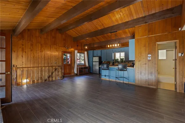 a view of a room with wooden floors