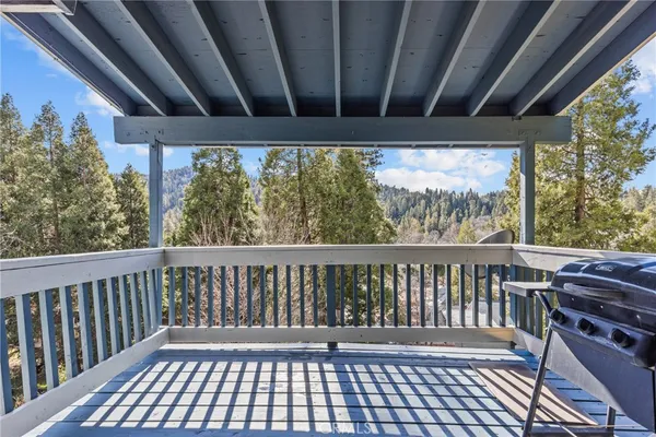 a view of a balcony with wooden floor
