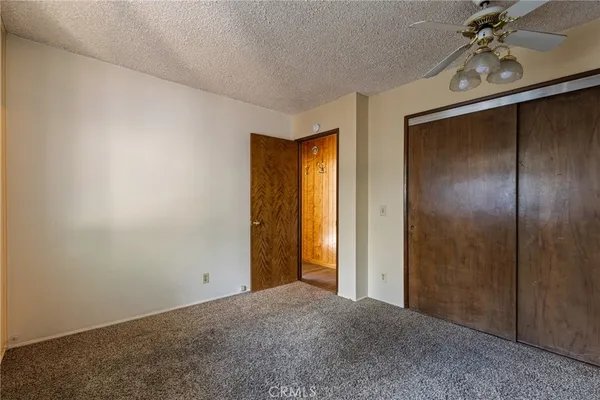 a view of a livingroom with a chandelier fan