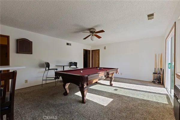 a room with table chairs and a window