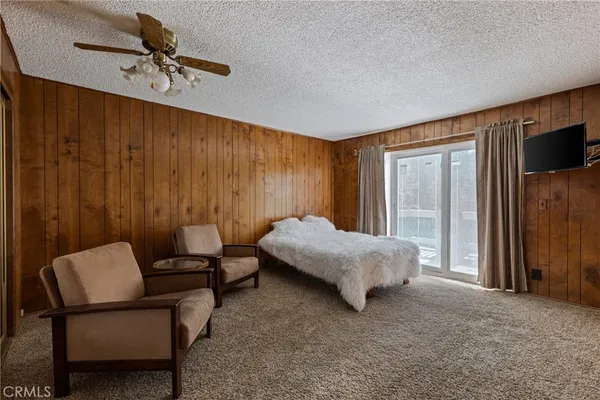 a bed room with a bed and a chair