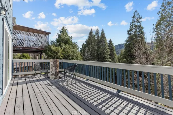 a balcony with wooden floor and outdoor seating