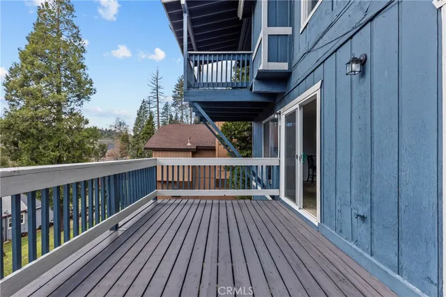 a view of balcony with wooden floor and fence