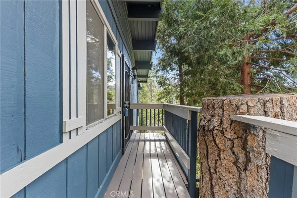 a view of balcony with wooden floor and fence