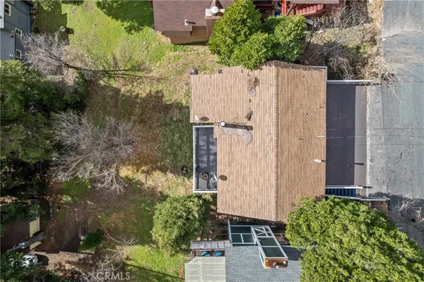 an aerial view of a house with a yard