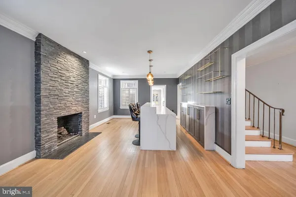 a living room with furniture fireplace and wooden floor