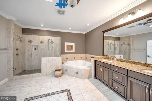 a spacious bathroom with a bathtub shower sink mirror and toilet