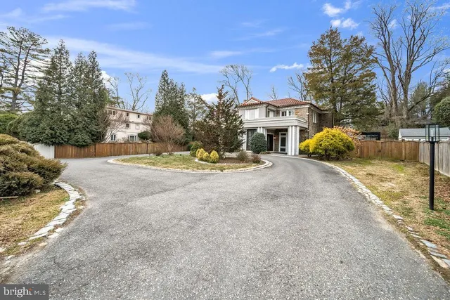 a living room with furniture fireplace and a large window